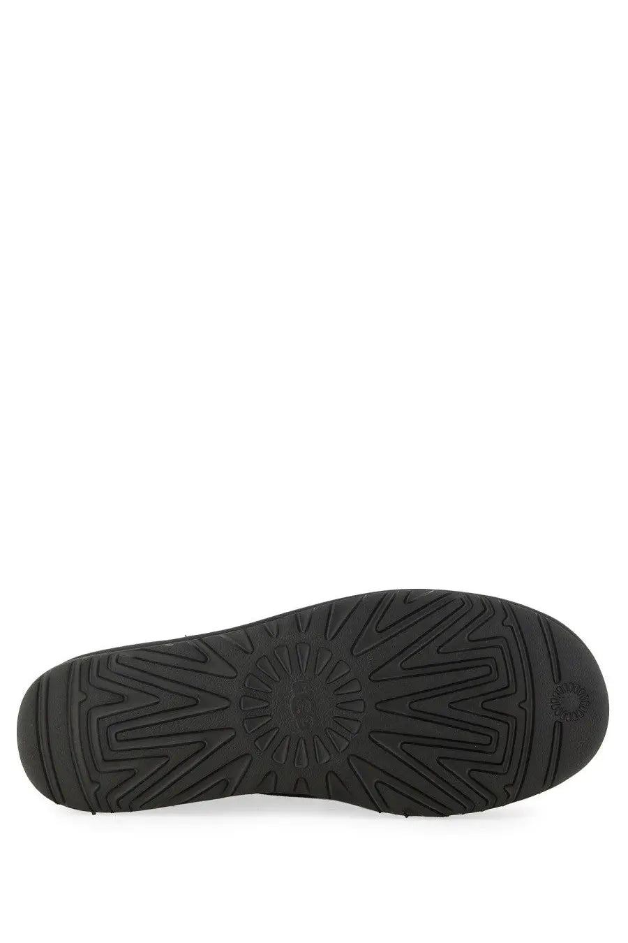 Black rubber sole of ugg men’s boot classic ultra mini black with distinctive starburst tread pattern and embossed logo