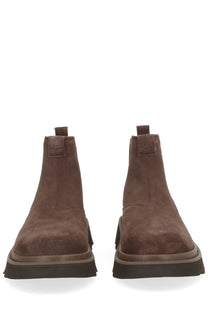 Ugg men’s chelsea lug boot in brown suede with a chunky black rubber sole for durable comfort and style