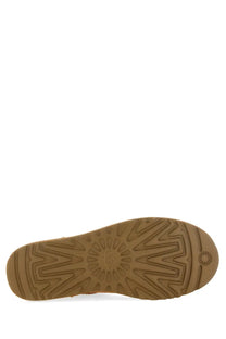 Back view of ugg men’s stivale classic ultra mini brown boot showing tan rubber sole with starburst tread pattern and embossed logo