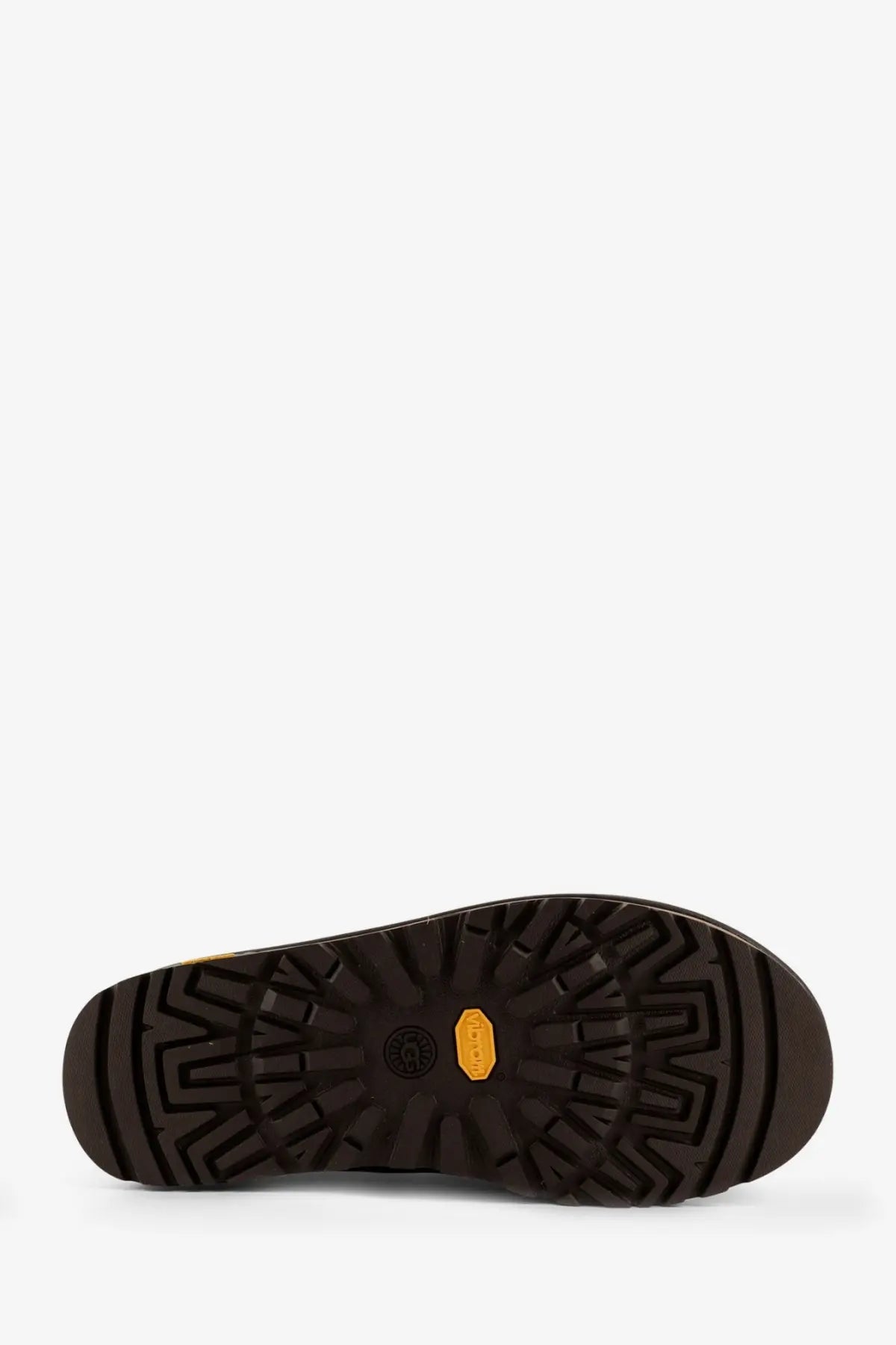 Black rubber sole with distinctive tread pattern and orange vibram logo on ugg men’s tasman gtx grey suede slip