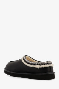 Ugg men’s Tasman Noir leather slip black mule with plush white shearling lining and black and white zigzag stitch trim