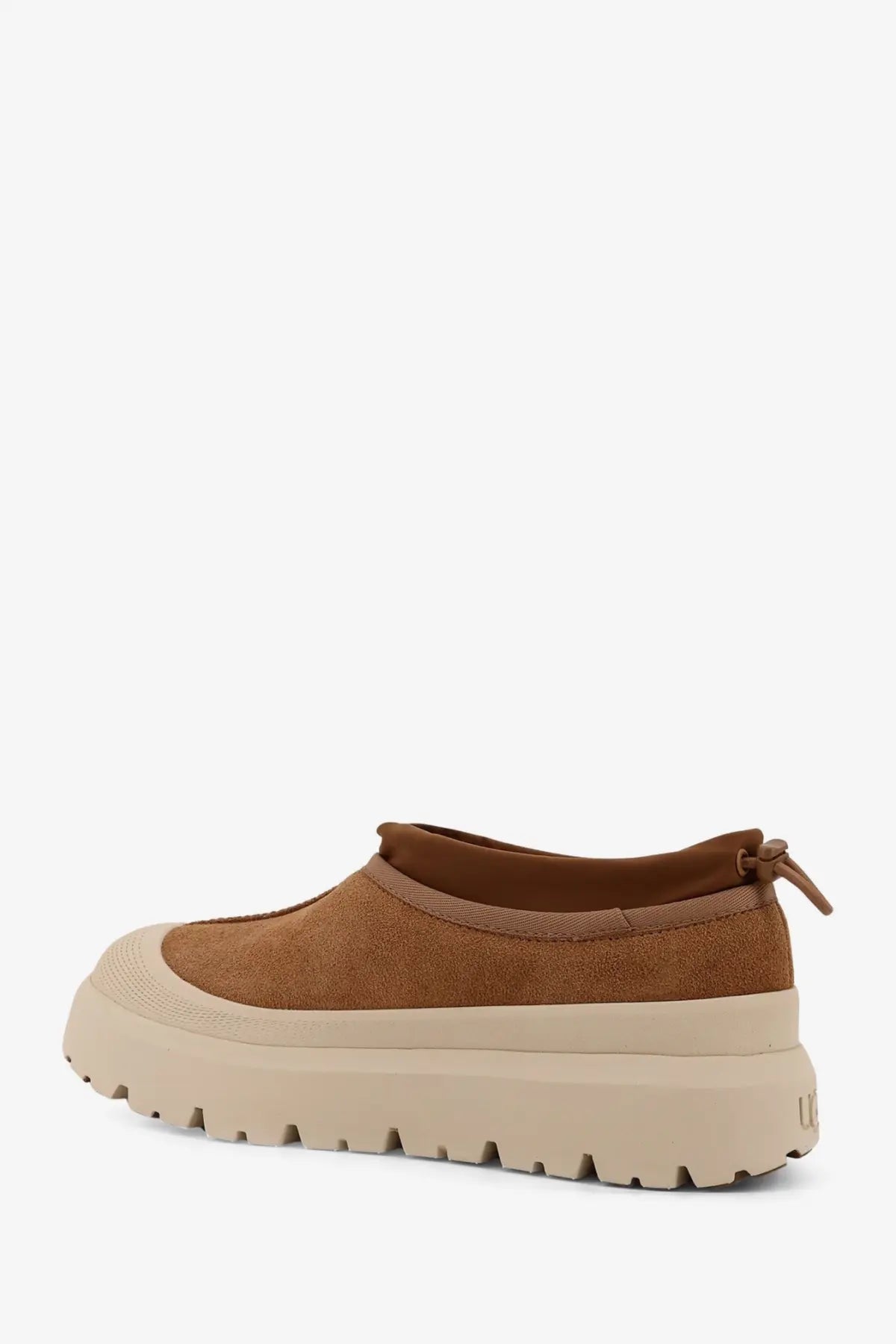 Brown suede slip-on ankle boots with beige rubber sole and pull tab at back from UGG men’s tasman weather hybrid collection