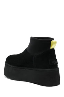 Ugg women’s classic mini dipper black boot with suede upper neon yellow pull tab and platform sole back view