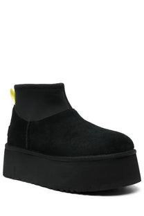 Ugg women’s classic mini dipper black boot in black suede with thick platform sole and yellow pull tab shown from back