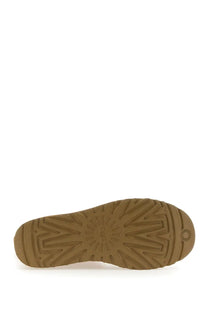 Tan rubber sole with a sunburst tread and embossed logo on ugg women’s classic short brown boot