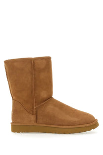 Ugg women’s boot classic short brown tan suede with classic cozy design and tan rubber sole visible from the back side