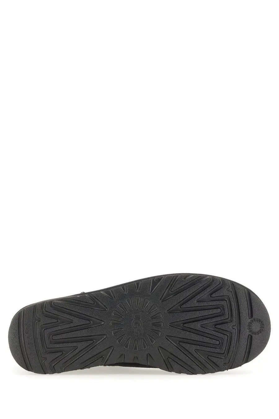 Black rubber sole of ugg women’s boot classic ultra mini black with embossed ugg logo and textured tread pattern