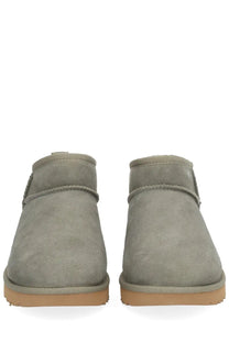 Ugg women’s boot classic ultra mini green gray suede booties with tan rubber sole and stitched detailing