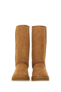 Ugg women’s boot classic tall brown featuring tan suede ugg booties with classic cozy design and sturdy rubber soles