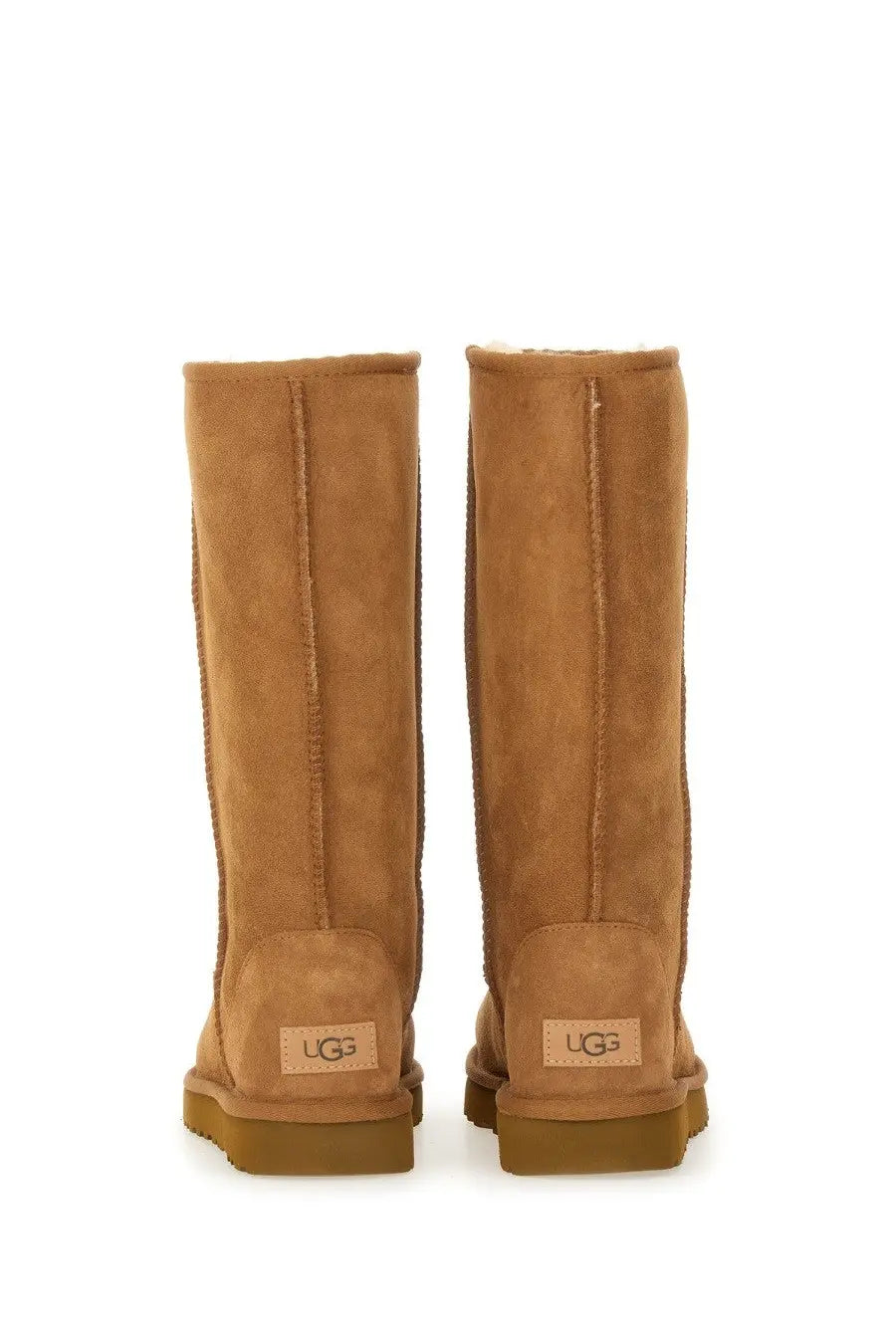 Ugg women’s classic tall brown boot in tan suede with plush shearling lining and durable rubber soles