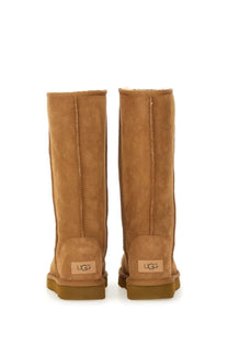 Ugg women’s classic tall brown boot in tan suede with plush shearling lining and durable rubber soles