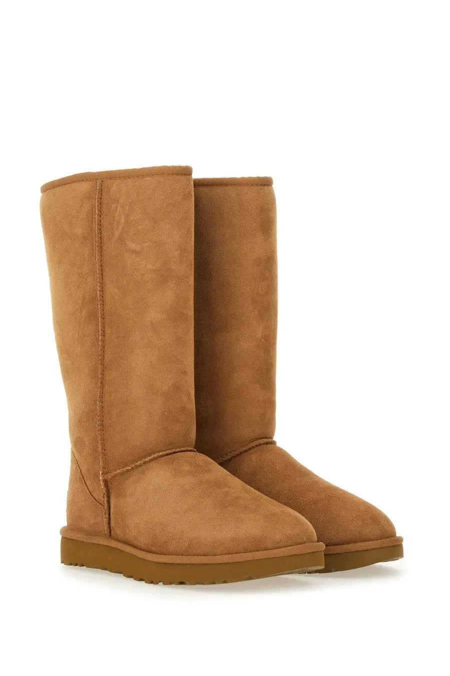Ugg women’s classic tall brown boot in tan suede with a cozy design and sturdy rubber sole
