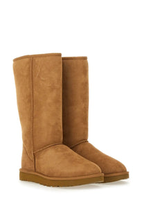 Ugg women’s classic tall brown boot in tan suede with a cozy design and sturdy rubber sole