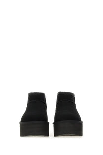 Ugg women’s classic ultra mini black ankle boots with black suede and thick platform soles visible from back side