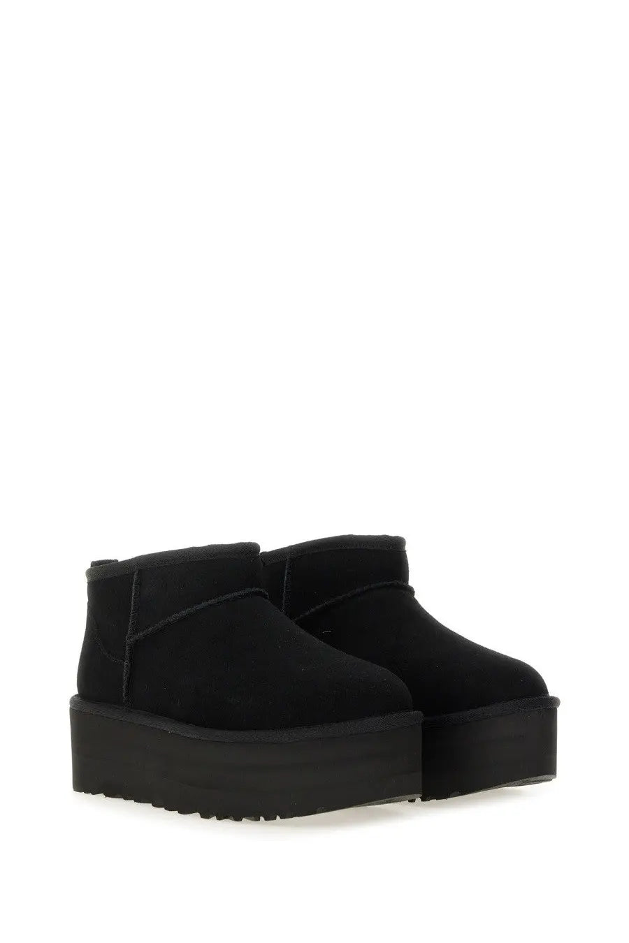 Ugg womens classic ultra mini boot in black suede with a thick textured platform sole visible from the back side