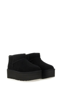 Ugg womens classic ultra mini boot in black suede with a thick textured platform sole visible from the back side