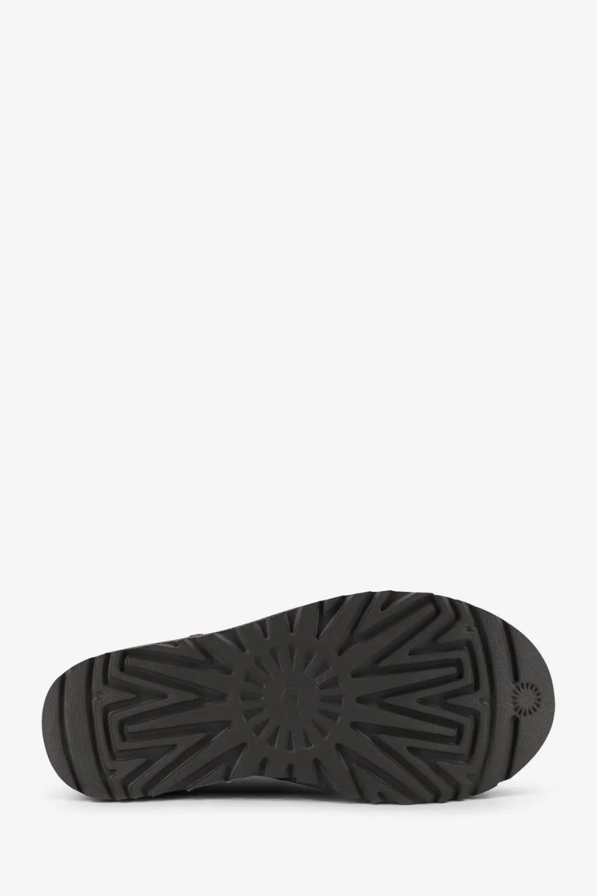 Back view of ugg women’s classic ultra mini grey suede ankle boots with black rubber sole and starburst tread pattern