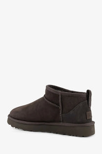 Ugg women’s classic ultra mini suede ankle boots in grey with dark brown suede, plush interior, and rubber sole