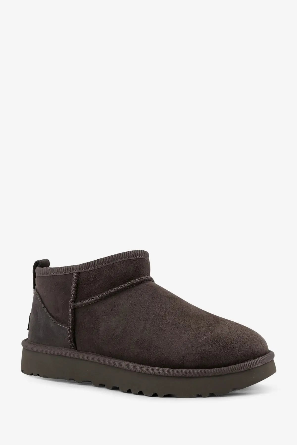 Ugg women’s classic ultra mini dark brown suede ankle boot with chunky rubber sole in grey shown from the back