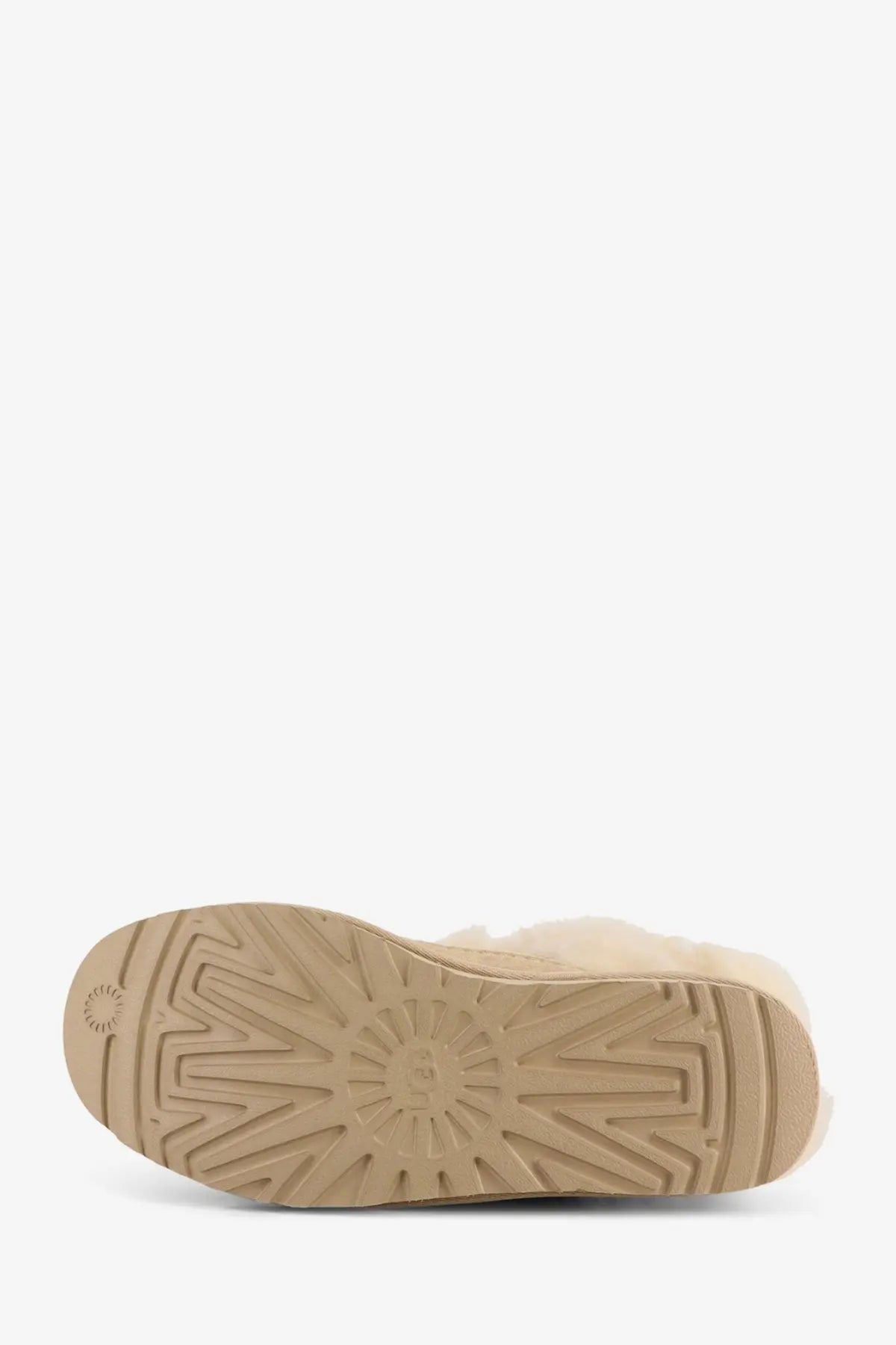 Beige ugg women classic ultra mini suede boot sole showing textured tread pattern and embossed brand logo near heel back view