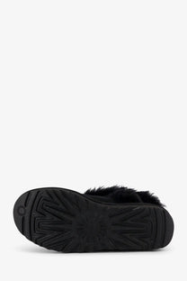 Ugg women’s classic ultra mini suede boot in black with plush fur trim and textured rubber sole front view