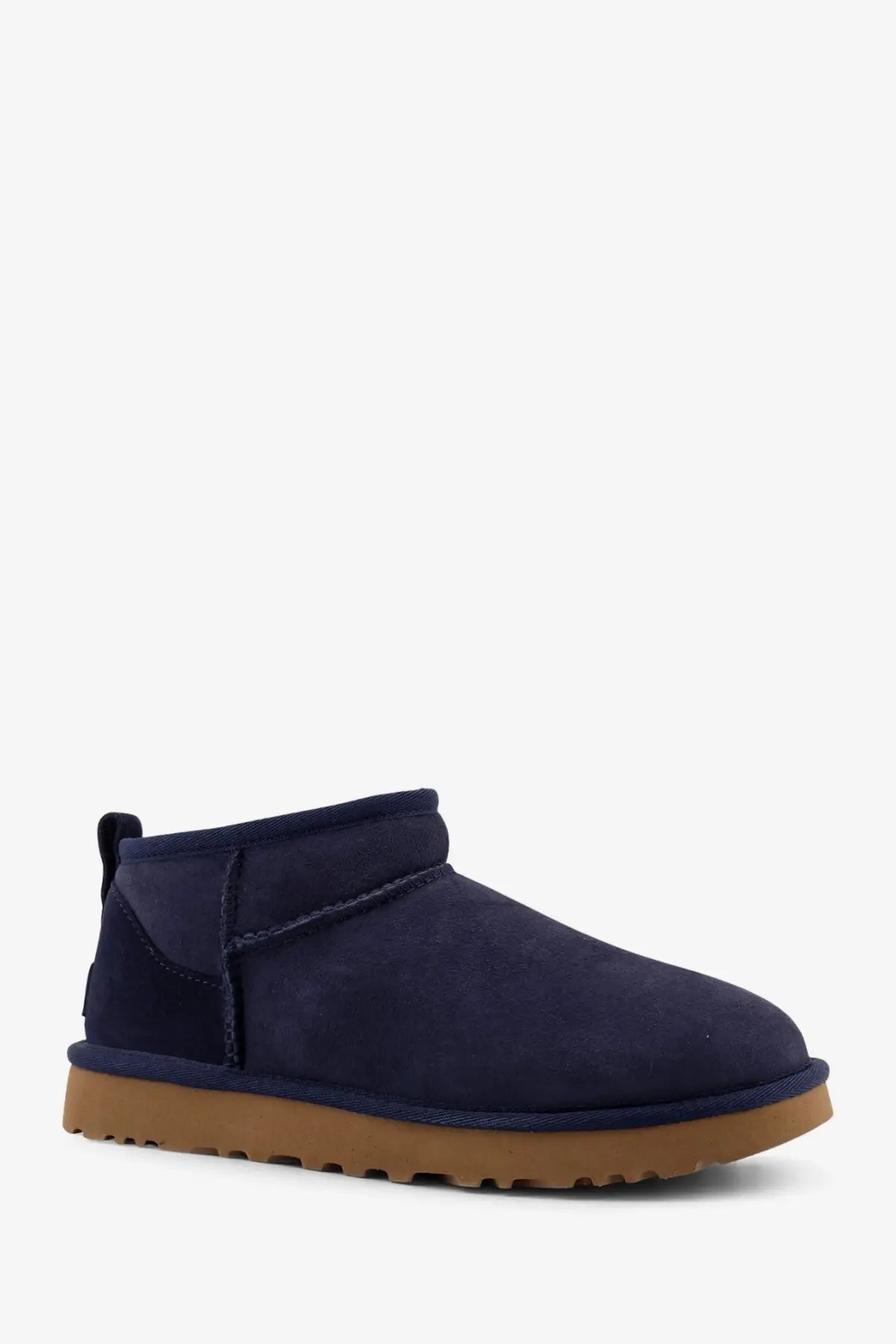 Ugg women’s classic ultra mini suede boot in navy blue with tan rubber sole for casual wear