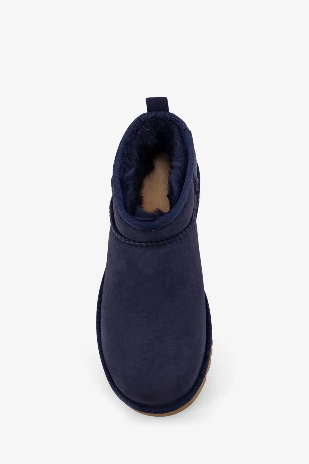 Navy blue suede UGG women’s classic ultra mini ankle boot with plush shearling lining and tan rubber sole