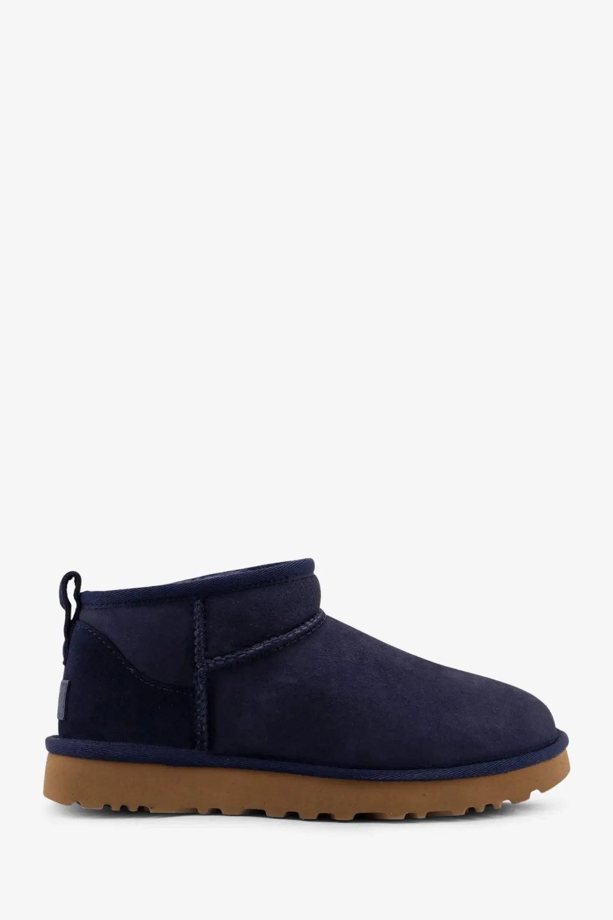 Navy blue suede UGG women’s classic ultra mini boots with tan rubber sole for stylish cold weather wear