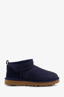 Navy blue suede UGG women’s classic ultra mini boots with tan rubber sole for stylish cold weather wear