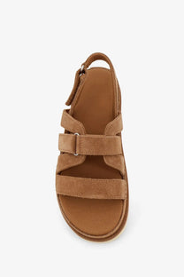 Ugg women’s goldenstar gleam sandals in suede brown feature tan suede straps with platform sole and adjustable ankle buckle