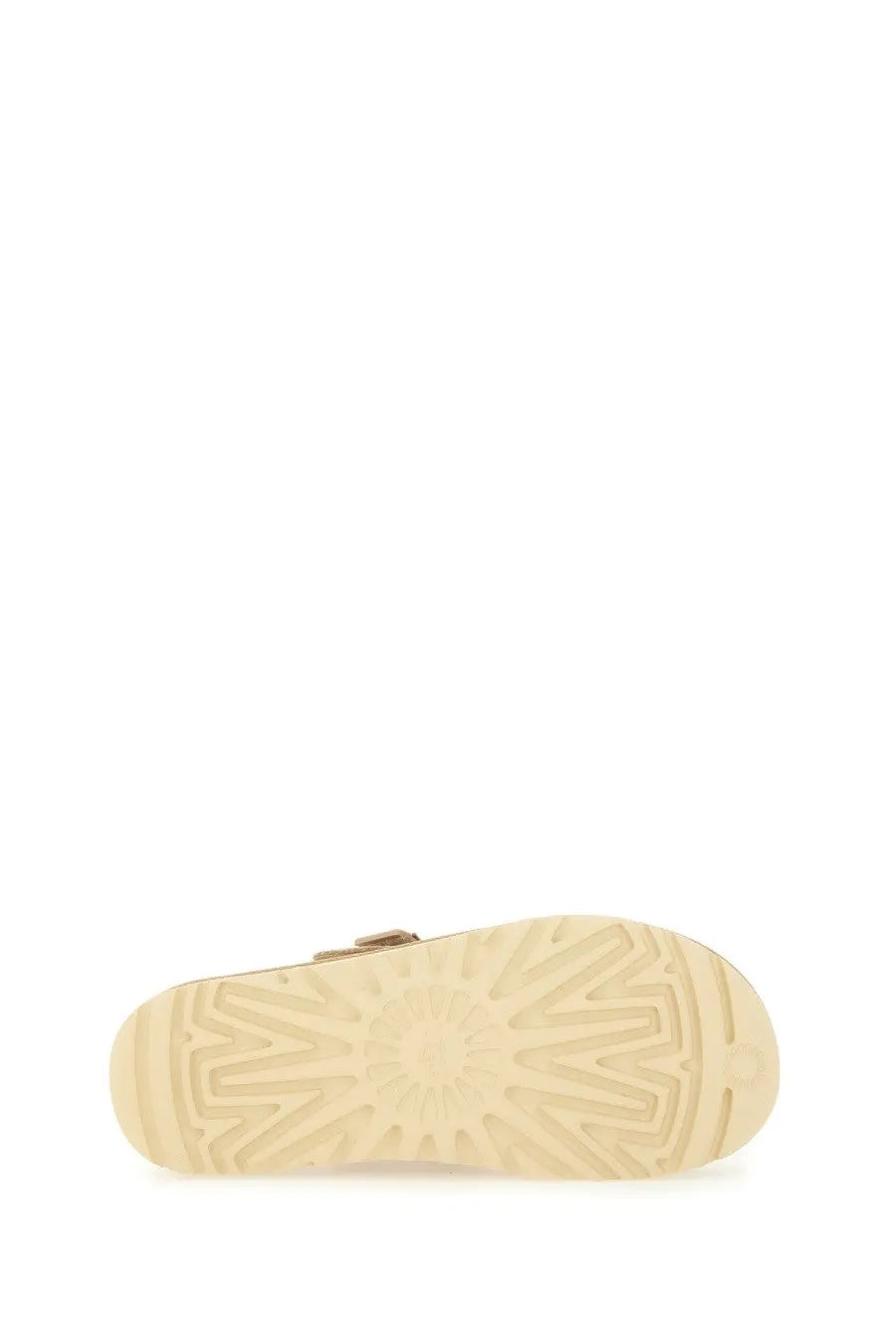 Ugg women’s goldenstar sabot beige with a beige rubber sole featuring a sunburst tread pattern and metallic buckle detail