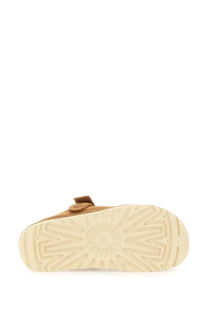 Ugg women’s goldenstar sabot brown tan suede boot with cream rubber sole and distinctive tread pattern visible from back