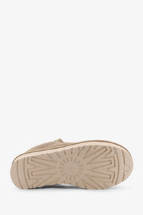 Beige ugg women’s lowmel sneakers with woven suede upper and textured rubber sole for casual wear