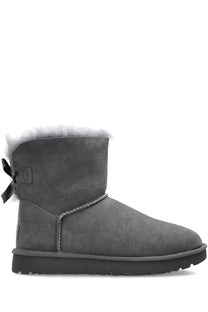 Back side of ugg women’s mini bailey bow ii boot in grey gray suede with fluffy white shearling lining and black bow