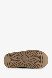 Tan rubber sole with sunburst tread pattern and ugg logo embossed at center of ugg women’s pony skin tazz sandals