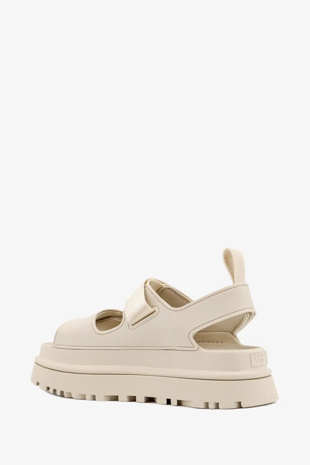 Cream-colored ugg women’s rubber platform sandal with thick textured sole and adjustable strap design in beige