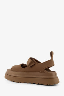 Ugg women’s brown platform sandal with thick rubber sole and adjustable strap visible from the back side