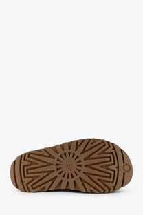 Ugg women’s brown rubber sandals with a starburst tread pattern and ugg logo embossed on the sole