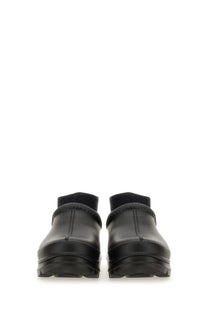 Ugg women’s sabot tasman black leather clog shoes with thick textured sole and ribbed ankle cuffs visible from the back