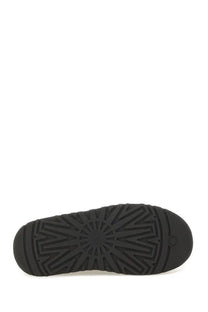 Black rubber sole of ugg womens sandal bea mary jane in black with starburst tread pattern and ugg logo near heel