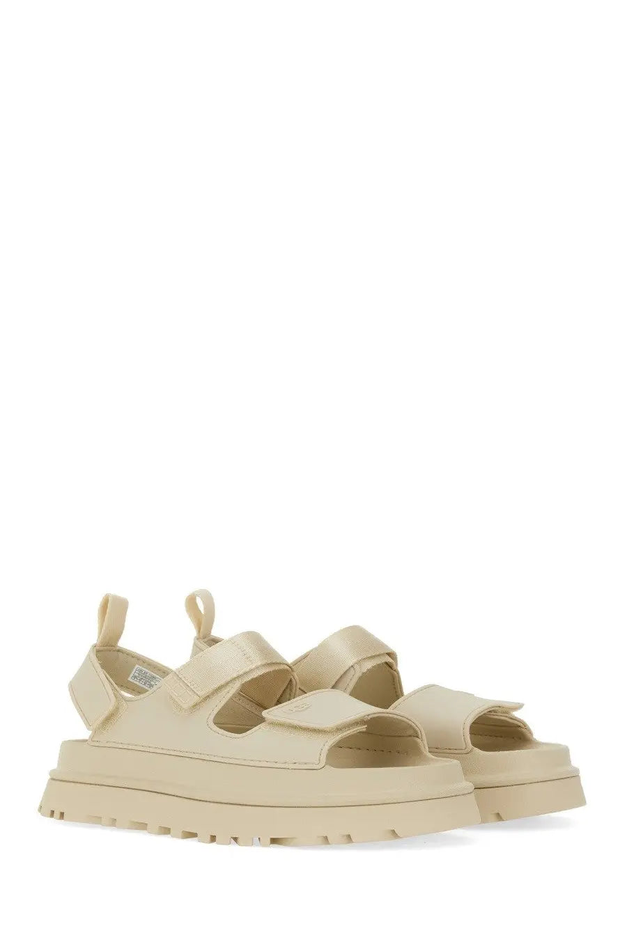 Cream-colored UGG women’s sandal goldenglow beige with wide velcro straps and chunky rubber platform sole