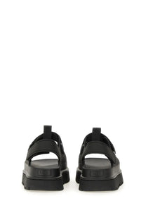 UGG women’s sandal goldenglow black platform with thick rubber soles and adjustable strap closures