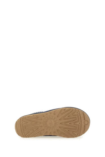 Ugg women’s sandalwood tasman blue navy blue boot with tan rubber sole and sunburst tread pattern shown from back