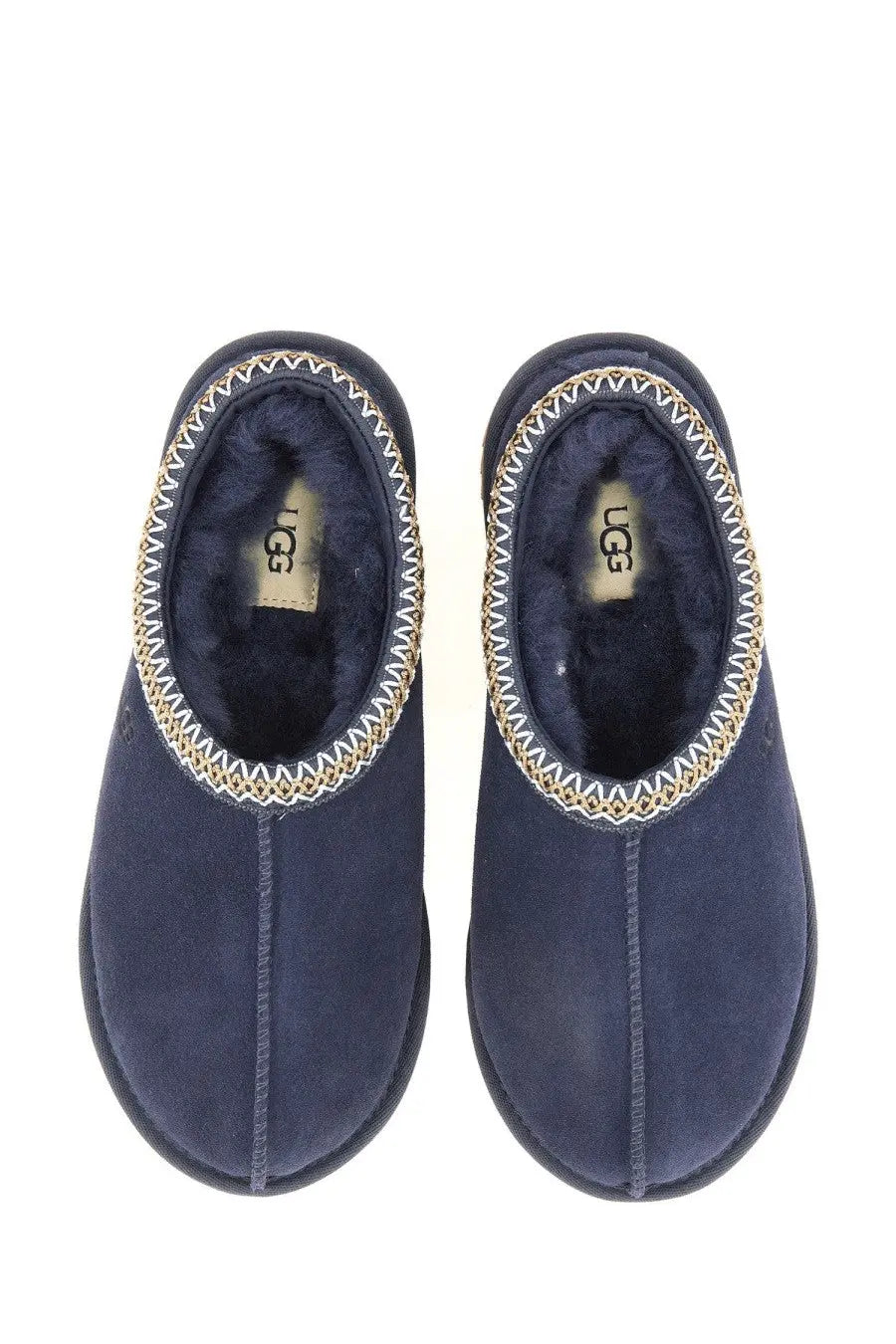 Ugg women’s sandalwood tasman blue navy blue suede slip-on slippers with gold and white zigzag stitching along opening