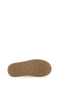 Tan rubber sole with sunburst tread and ugg logo near heel on ugg womens slipper bea mary jane brown back view