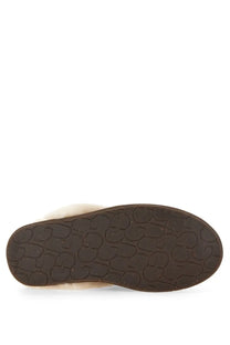 Brown rubber sole of ugg women’s slipper scuffette with embossed ugg logo pattern visible on the back side