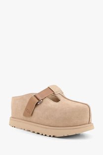 Ugg women’s beige suede sandals featuring a tan leather strap and rubber sole for comfortable wear