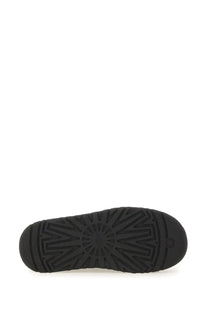 Black rubber sole of ugg women’s tazz ii plateau sandal with radiating tread pattern and embossed ugg logo near heel