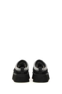Ugg women’s tazz ii black suede slip-on shoes with thick rubber sole and silver zigzag stitching along the collar