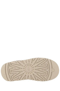 Beige rubber sole with distinctive radiating tread and ugg logo embossed near heel on ugg women’s tazz ii plateau sandal gray back side